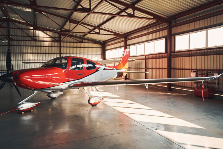 Modern aircraft in airport parking building hangar